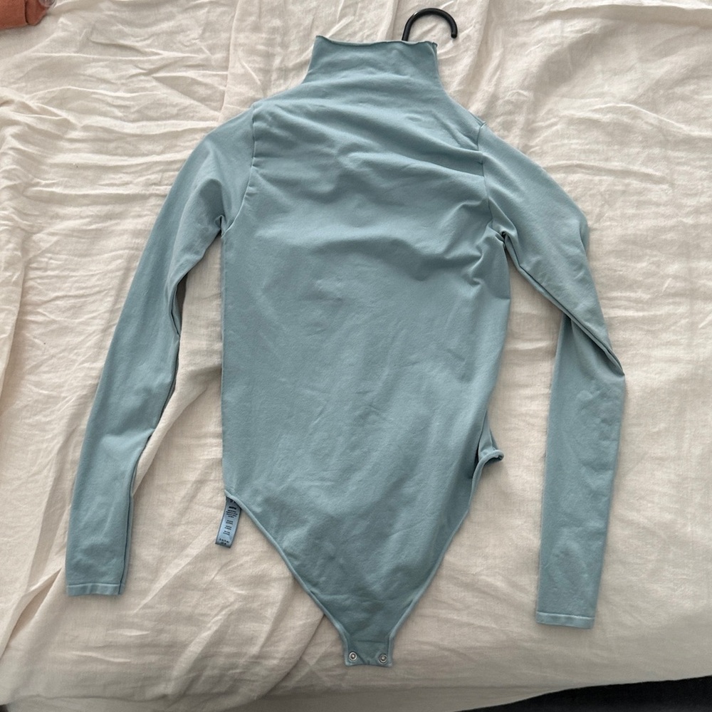 SKIMS bodysuit light blue long sleeve mock neck